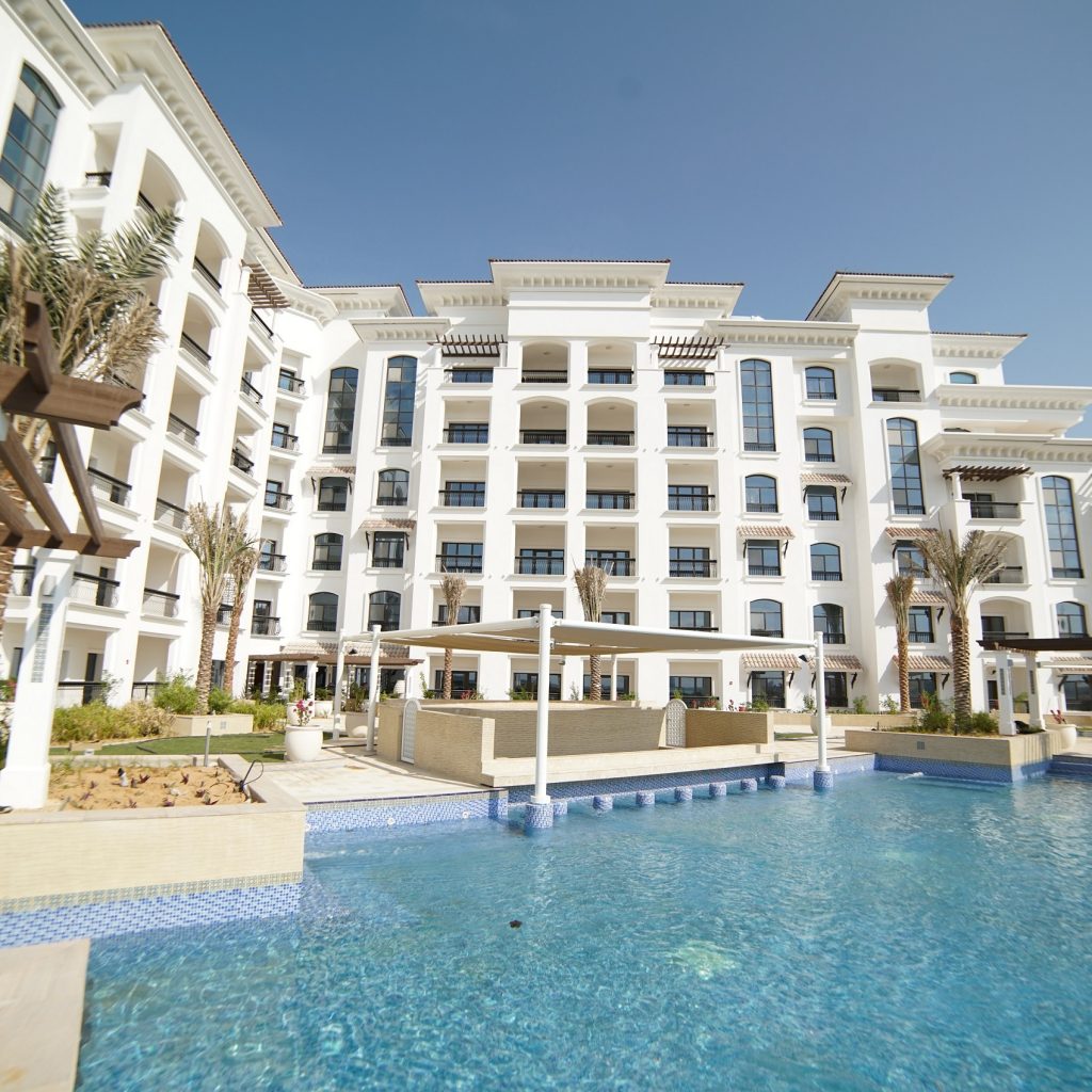 Ansam Residences Yas Island Aldar apartments arched terraces and rustic tiled rooftops exterior