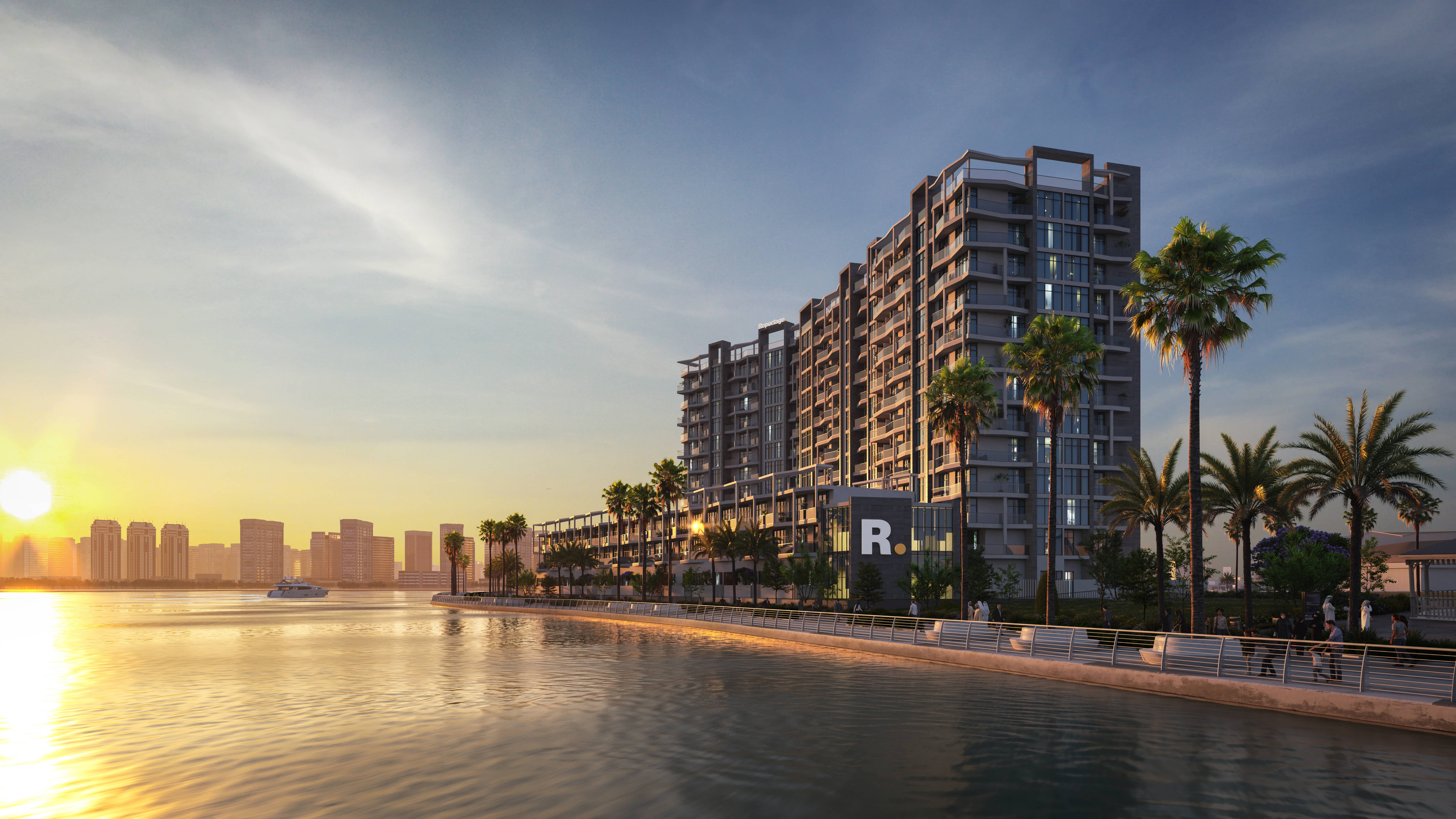Exterior facade of multi-level townhouses and podium residences at Perla 3 in Yas South Abu Dhabi surrounded by landscaping